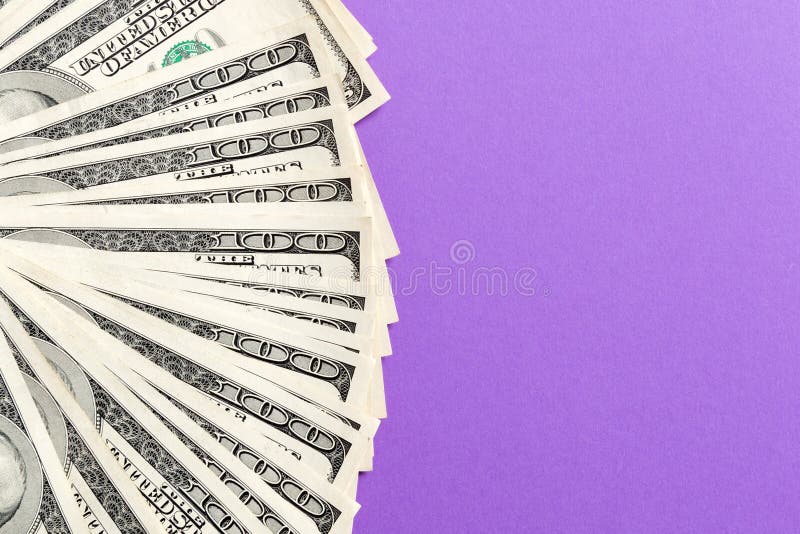 US Dollars: Untidy fan of various US dollar bills Top view of business concept on colored background royalty free stock photography