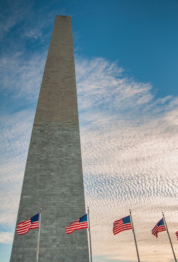 US Flags Surrounding the Washington Monument at Sundown Stock Photo
