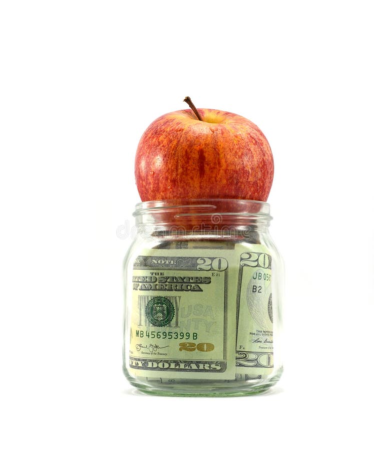 US money in glass jar with red juicy apple on top of jar, concept of getting dividends or returns from your money