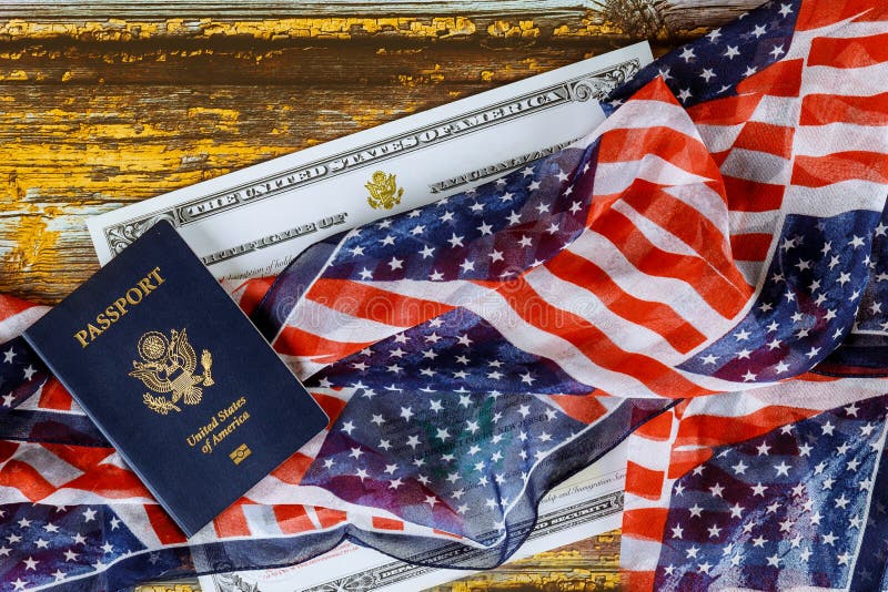 US passport and flag over a citizenship and naturalization certificate royalty free stock photography