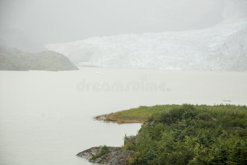 USA Alaska - Mendenhall Glacier and Lake. Mendenhall Glacier ia a misty day - USA Alaska, Tongass National Forest, Mendenhall Glacier Recreation Area, Travel stock photography USA Alaska - Mendenhall Glacier and Lake. Mendenhall Glacier ia a misty day - USA Alaska, Tongass National Forest, Mendenhall Glacier Recreation Area, Travel stock photography