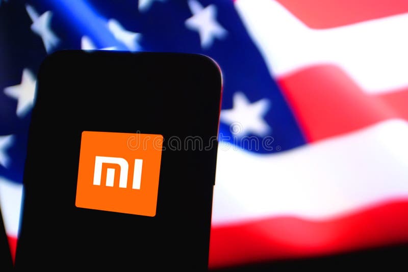 USA flag and Smart phone with the Xiaomi Inc. logo, is a Chinese company dedicated to the design, development and sale of smart phones. United States, California, Sunday, January 19, 2019