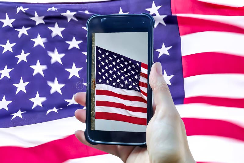 USA flag in a smartphone display in front of a big USA flag.
