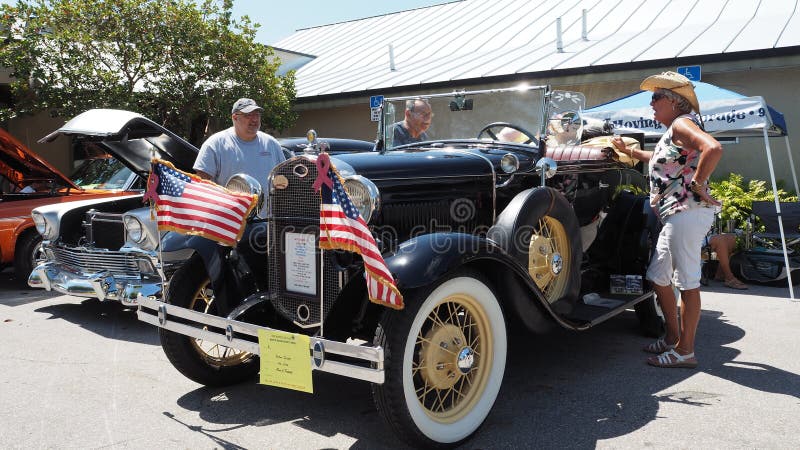 USA, Fort Lauderdale - May 21, 2017 - Restored 1931 Ford model A roadster in black paint with american flags attached to bumper