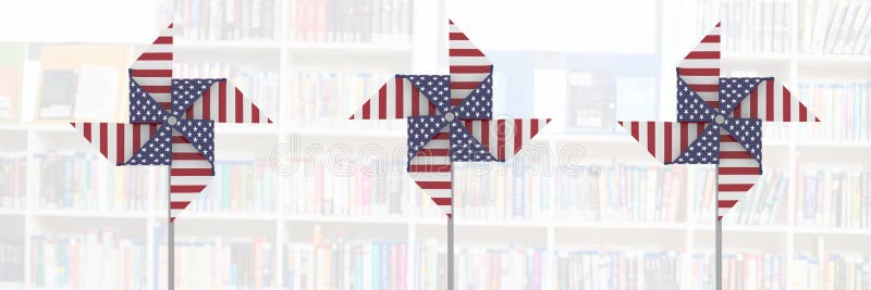 Digital composite of USA wind catchers in front of library shelves. Digital composite of USA wind catchers in front of library shelves