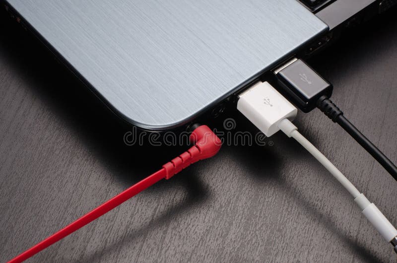 USB Cables and Headphone Jack Connected To Laptop Stock Photo Image