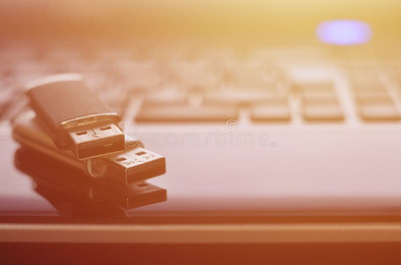 USB flash cards lying on black laptop case in front of his keyboard. Virtual memory storage with USB outpu stock photo USB flash cards lying on black laptop case in front of his keyboard. Virtual memory storage with USB outpu stock photo