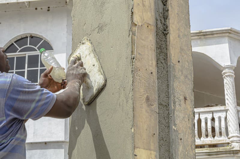 Using Wooden Float To Smooth Concrete Wall royalty free stock images