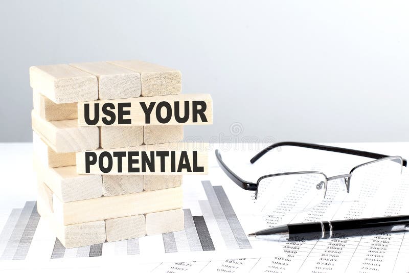 USE YOUR POTENTIAL is written on wooden blocks on a chart background stock image