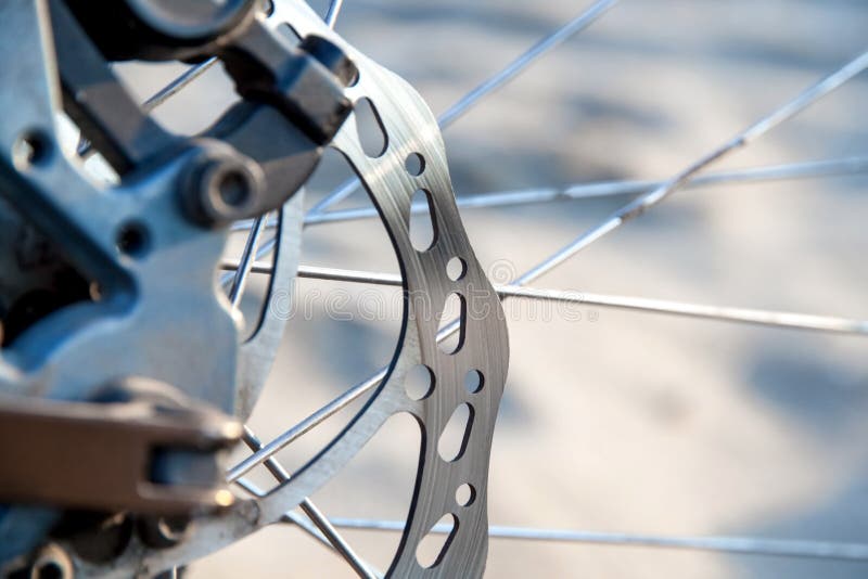 Used mountain bike disc brake close-up. Blurry background