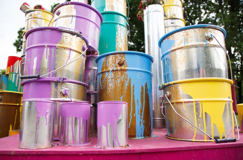 The Used Paint Cans. Many Multicolored Buckets with Traces of Paint on