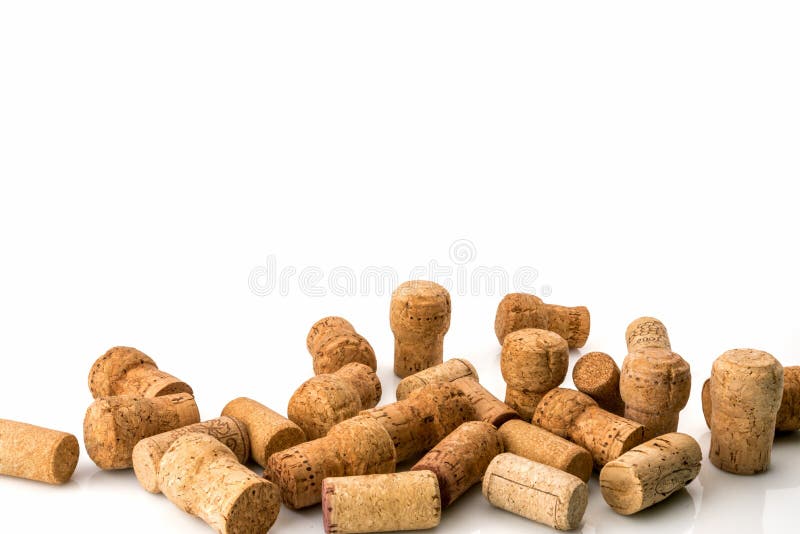 Used wine corks scattered randomly on white background. Used wine corks scattered randomly fill half frames on white background, space for text, isolated on white