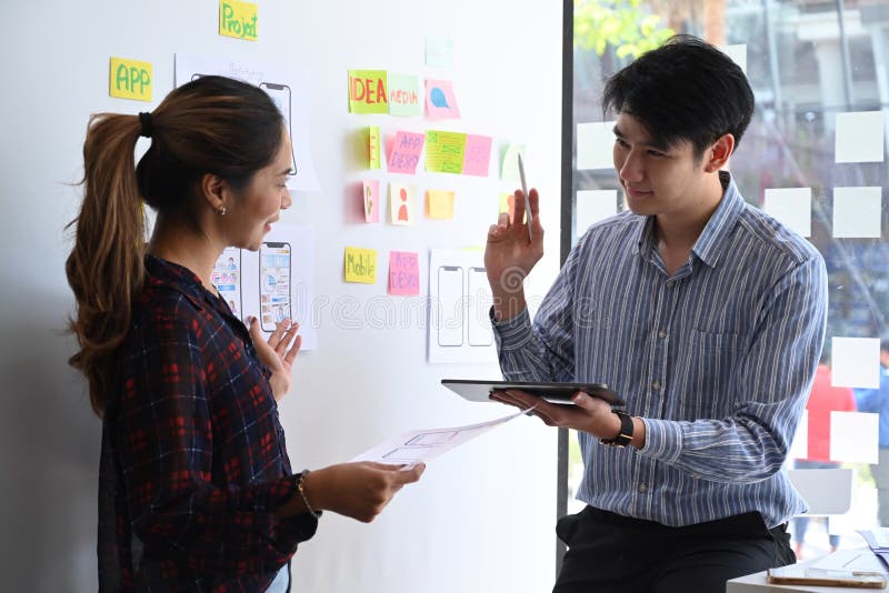 User experience designers are discussing and planning sketch, prototype, framework, layout app design project. royalty free stock image