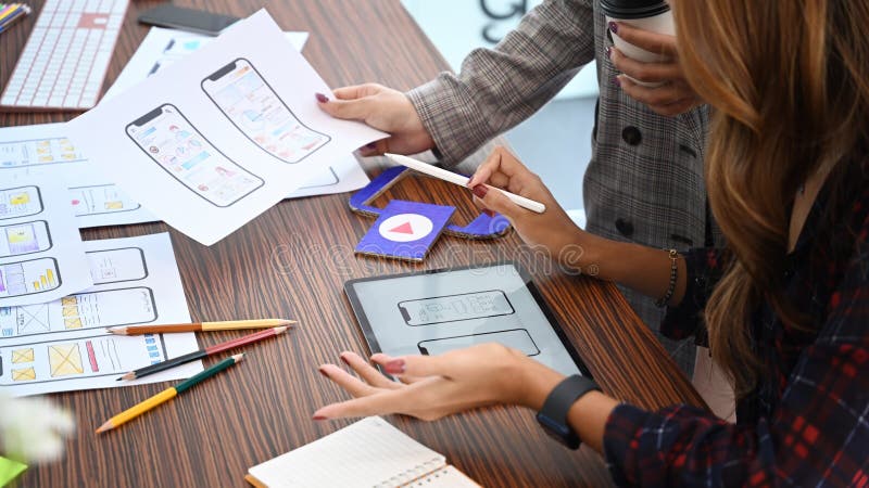 User experience designers are planning sketch, prototype, framework, layout future app design project at office. stock image