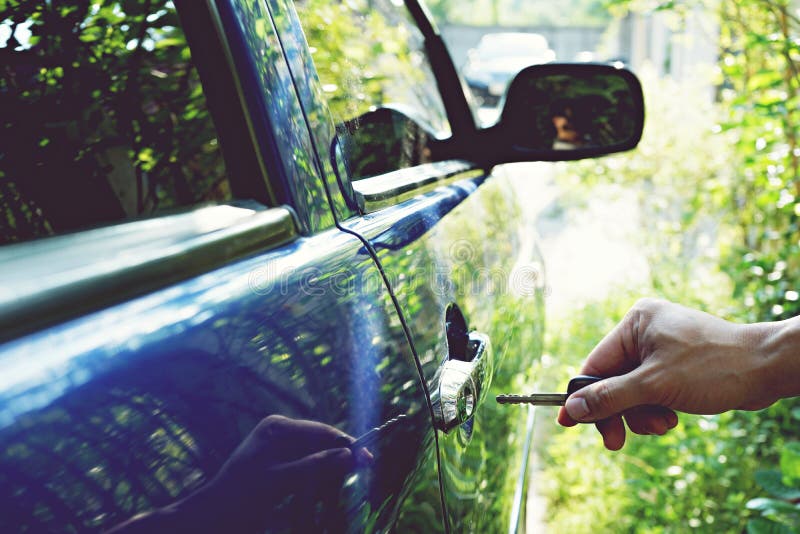 Using key to open car door stock photo. Image of asset 115028776