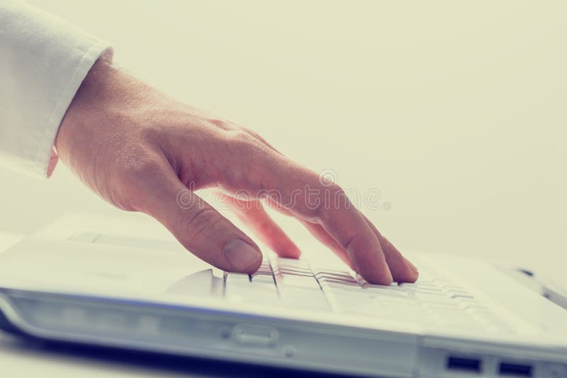 Closeup of male hand using white laptop computer. Conceptual of online business or e-learning, toned retro or instagram effect. Laptop personal computer stock images, royalty-free photos and pictures