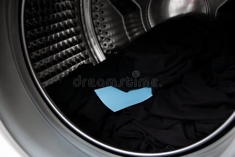 Using laundry detergent sheet, concentrated washing powder for washing machine. stock image