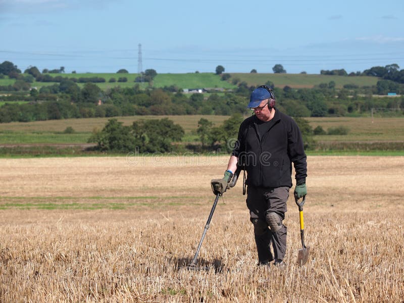 Using a Metal Detector in Field Stock Photo Image of male, holding