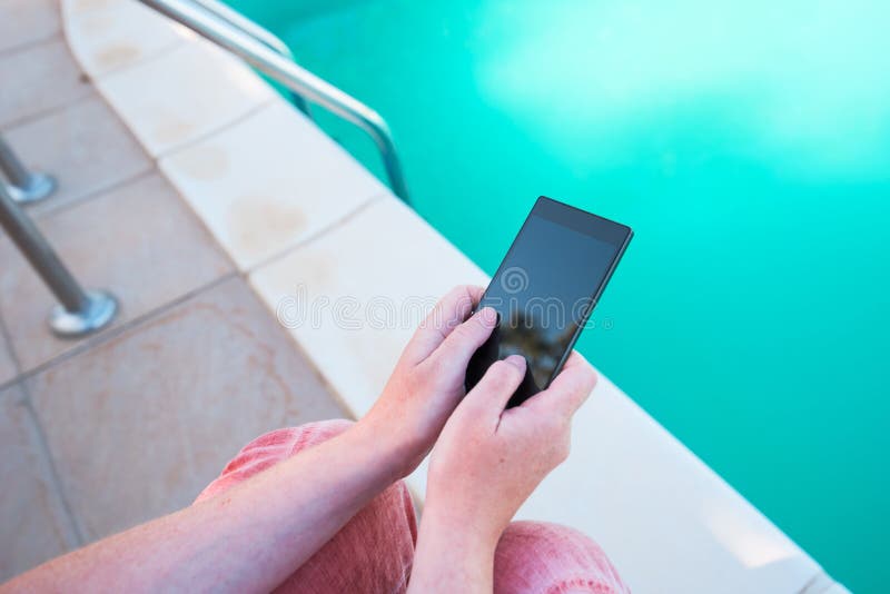 Using Mobile Phone by the Swimming Pool Stock Photo Image of