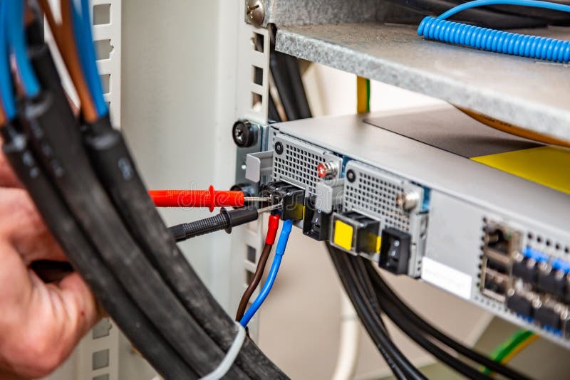 Using a Multimeter. Rack of Equipment, Wires. Wiring. only Hands