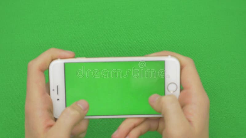 Using smart phone on green screen with various hand gestures, horizontally , close up - green screen