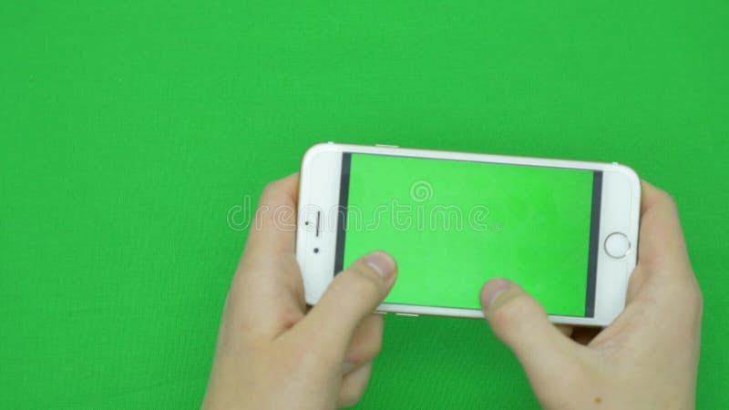 Using smart phone on green screen with various hand gestures, horizontally , close up - green screen