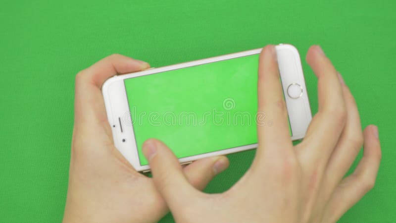 Using smart phone on green screen with various hand gestures, horizontally , close up - green screen