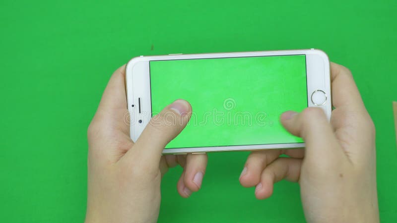 Using smart phone on green screen with various hand gestures, horizontally , close up - green screen