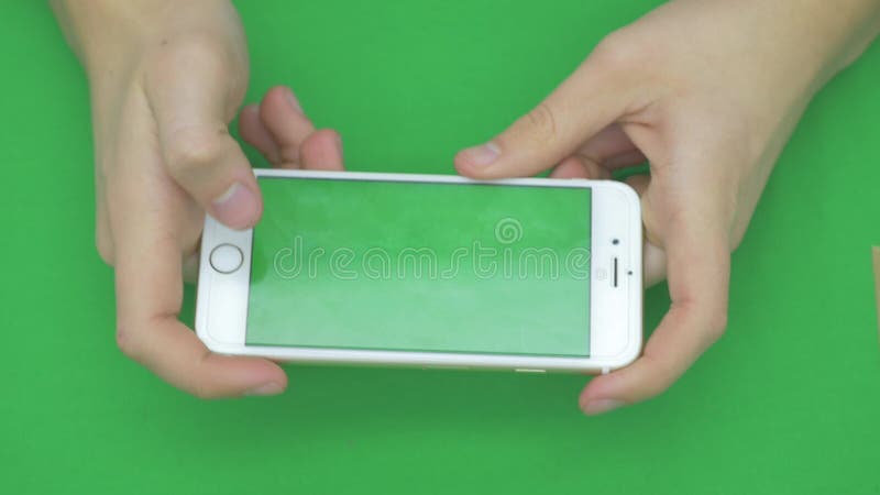 Using smart phone on green screen with various hand gestures, horizontally , close up - green screen