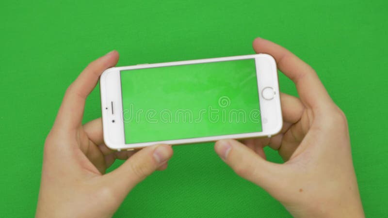 Using smart phone on green screen with various hand gestures, vertikal, close up - green screen