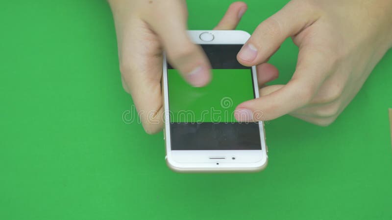 Using smart phone on green screen with various hand gestures, vertikal, close up - green screen