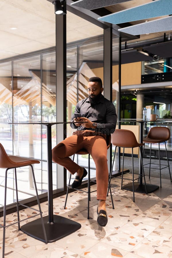 Using Smartphone, Businessman Sitting at High Table in Modern Office Space Stock Photo - Image ...