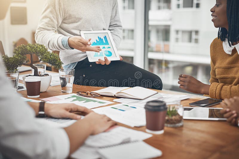 Using transparency to build a better business. a group of businesspeople discussing statistics. stock photos