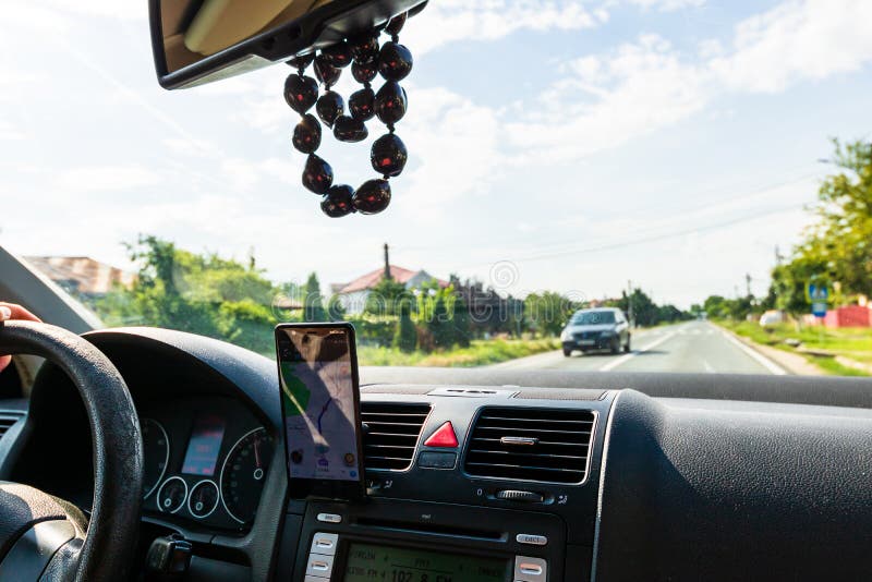 Using Waze Maps Application on Smartphone on Car Dashboard, Bucharest