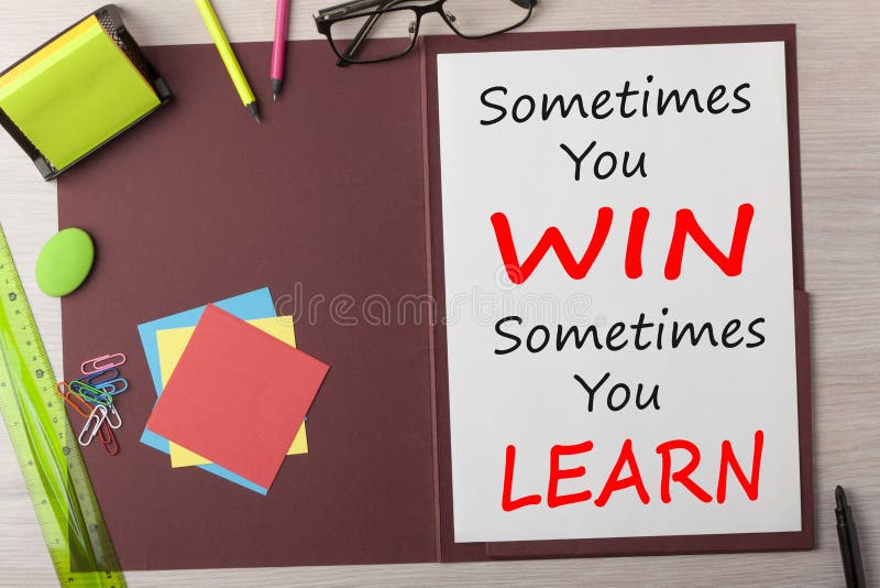 Sometimes you win, sometimes you learn written in paper sheet on presentation folder and various stationery on wooden table.Business concept.Top view. Sometimes you win, sometimes you learn written in paper sheet on presentation folder and various stationery on wooden table.Business concept.Top view.