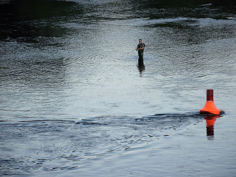 Usti nad Labem, Czech republic - June 24, 2019: fisherman in Labe river at sunset stock photography Usti nad Labem, Czech republic - June 24, 2019: fisherman in Labe river at sunset stock photography