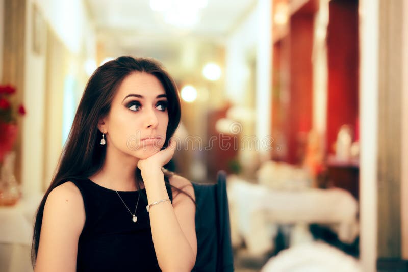 Portrait of a sad introvert woman sitting alone at dinner event. Portrait of a sad introvert woman sitting alone at dinner event