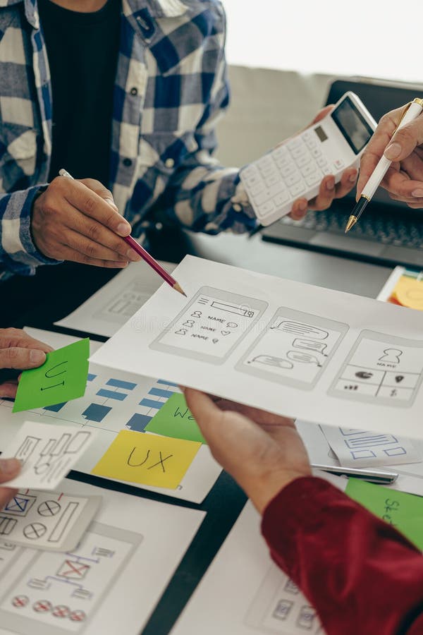 UX developers or company employees design user interfaces or UI prototypes for mobile applications or website software that display the software on smartphone screens. Vertical close-up image