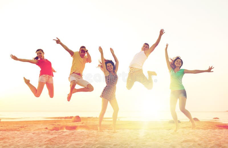 Friendship, summer vacation, holidays, party and people concept - group of smiling friends dancing and jumping on beach. Friendship, summer vacation, holidays, party and people concept - group of smiling friends dancing and jumping on beach