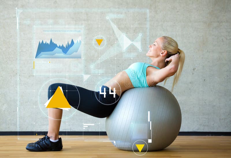 Fitness, sport, training, future technology and lifestyle concept - smiling woman with exercise ball in gym over graph projection. Fitness, sport, training, future technology and lifestyle concept - smiling woman with exercise ball in gym over graph projection.