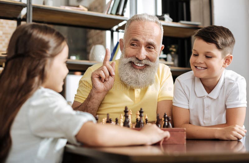 Uśmiechnięty dziadek mieć pomysł o następnym szachowym ruchu