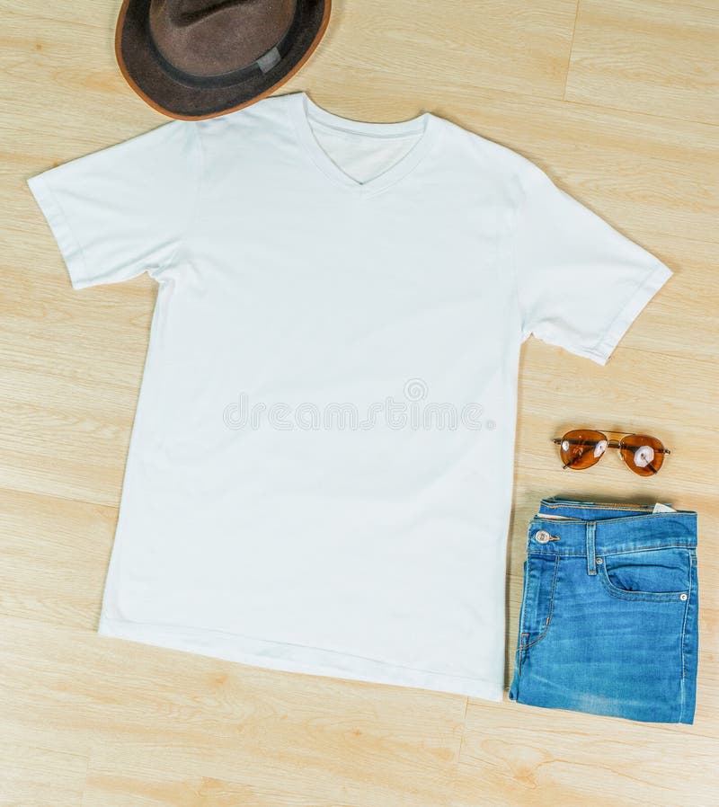 A v neck shirt laid out on the top of the wooden tiling with minimalistic decoration
