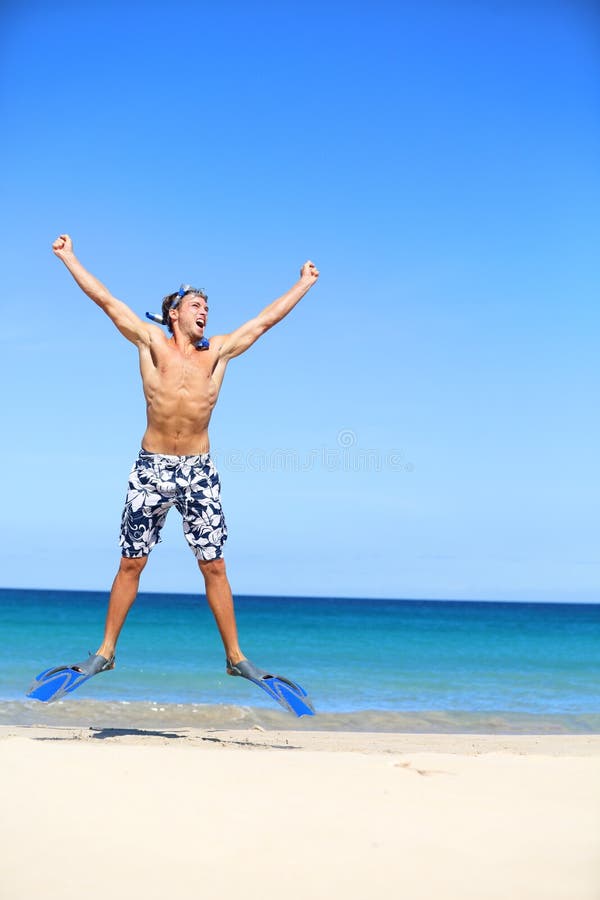 Vacaciones - hombre feliz de la playa que salta con bucear imagen de archivo libre de regalías Vacaciones - hombre feliz de la playa que salta con bucear imagen de archivo libre de regalías