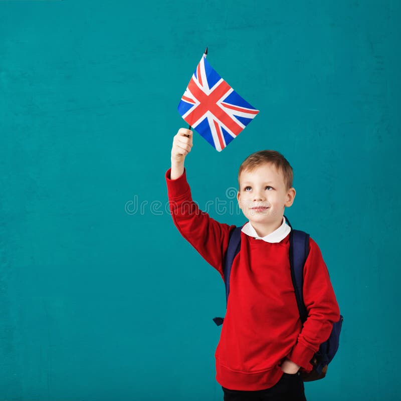 School Holidays United Kingdom UK. Little schoolboy with national flag of the United Kingdom. School concept. Back to School. School Holidays United Kingdom UK. Little schoolboy with national flag of the United Kingdom. School concept. Back to School