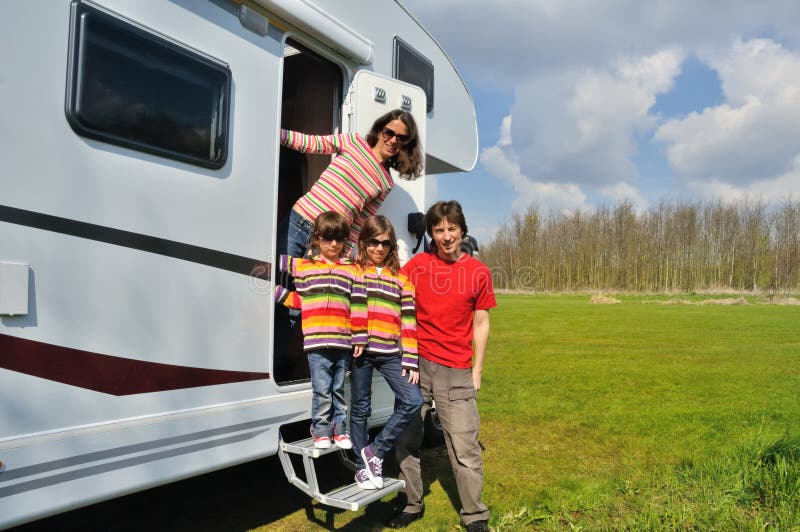 Family vacation, RV travel with kids, happy parents with children on holiday trip in motorhome, camper exterior. Family vacation, RV travel with kids, happy parents with children on holiday trip in motorhome, camper exterior