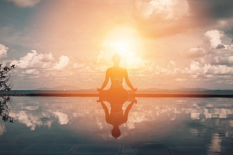 Vacation of Beautiful woman relaxing in yoga lotus pose on the pool above the beach with beautiful sea in Tropical island