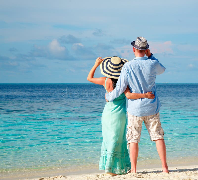Vacation Couple Walking On Tropical Beach Maldives. Stock
