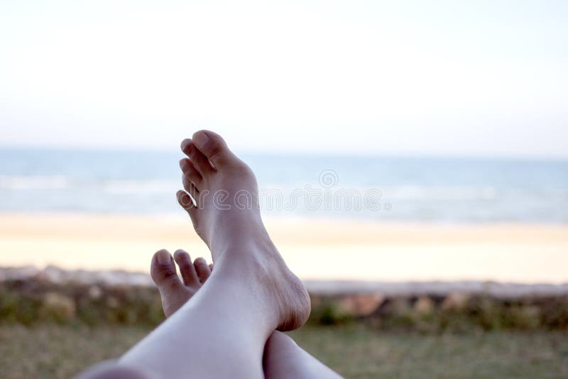 Vacation holidays. Woman feet of girl relaxing on sunbed