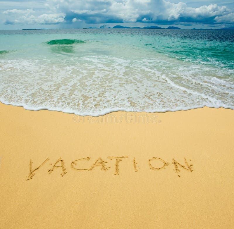 Vacation written in a sandy beach