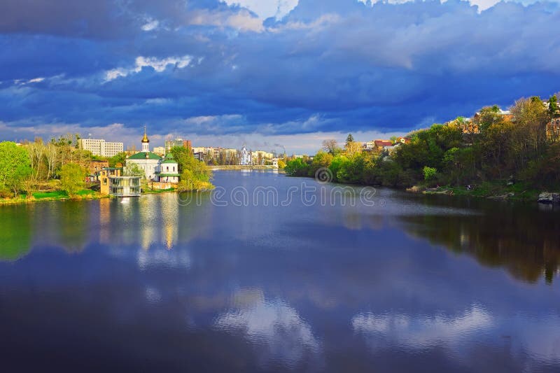 Beautiful view of cityscape in the summer. Church of Blessed Xenia of St. Petersburg on the riverbank of the river Southern Bug in Vinnytsia, Ukraine, Europe. Beautiful view of cityscape in the summer. Church of Blessed Xenia of St. Petersburg on the riverbank of the river Southern Bug in Vinnytsia, Ukraine, Europe